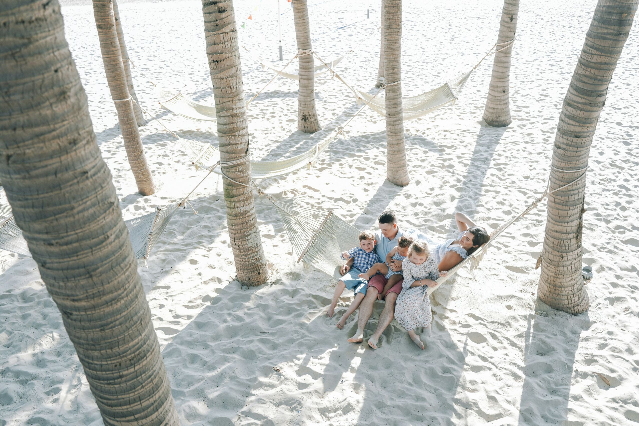 Family enjoying beach life in Belize near their coastal property investment